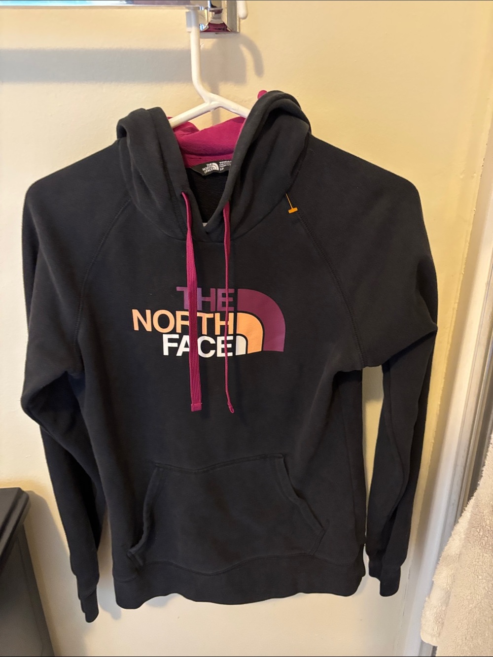 The North Face Black Hoodie with Pink and Peach Logo